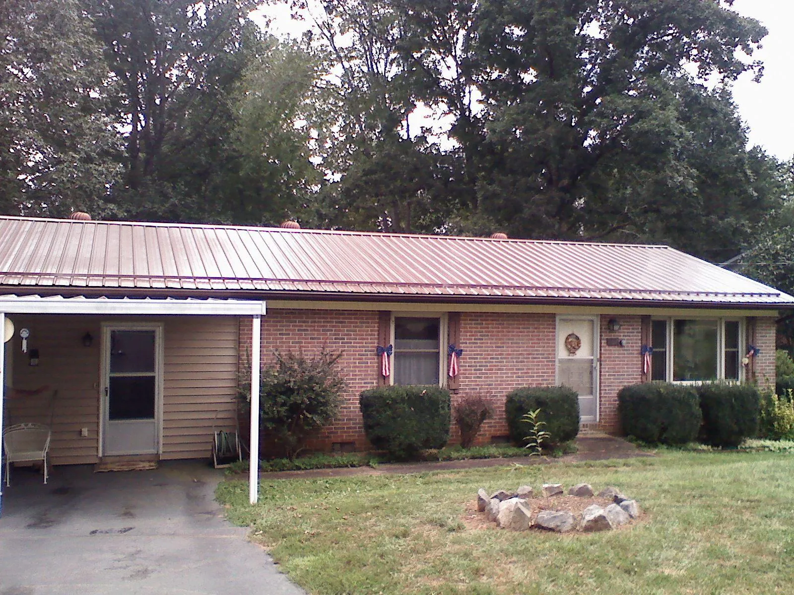 Bronze metal roof and carport on a brick ranch home — Roof Repair work by our crew in Vancouver